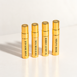 Korbaj Parfum Prestige Collection 4-piece Extrait de Parfum sample set with gold Oud For You, Scarlet Amber, Jade Royale and Rose Sands sample bottles.