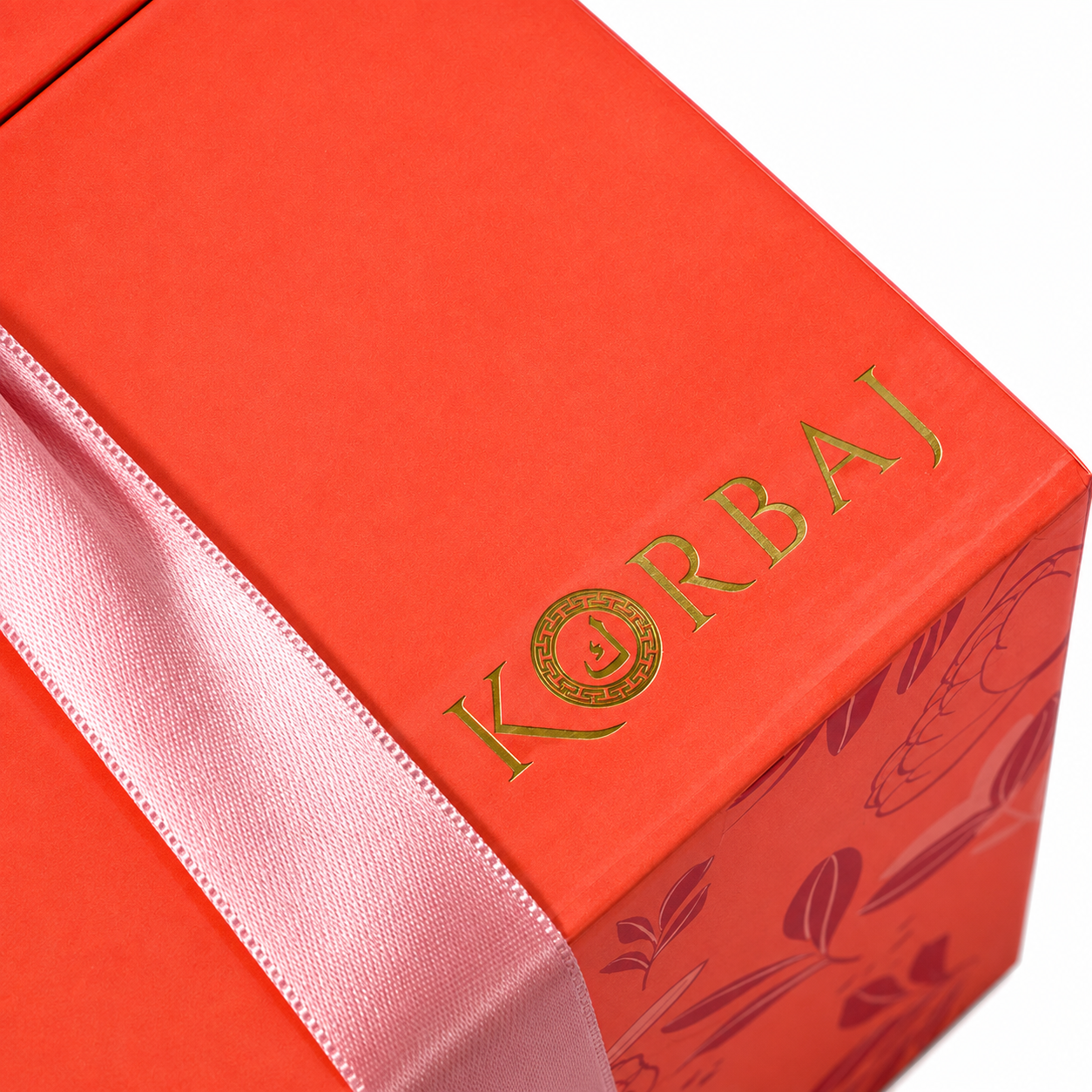 Korbaj gold foil logo on coral Her Signature Set gift box