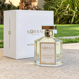 Korbaj Musky Signature 100ml unisex musk perfume: bottle beside the front of its closed white box outdoors.