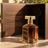 Korbaj Mystique 100ml woody aromatic perfume for men: close view of the bottle and open brown box in dappled sunlight.