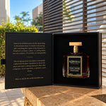 Korbaj Toxic Desire 100ml unisex gourmand woody perfume: bottle inside its open black presentation box on a sunlit table.