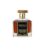 Close front view of Korbaj Toxic Desire 100ml gourmand woody perfume, showing amber liquid, gold cap and black label.